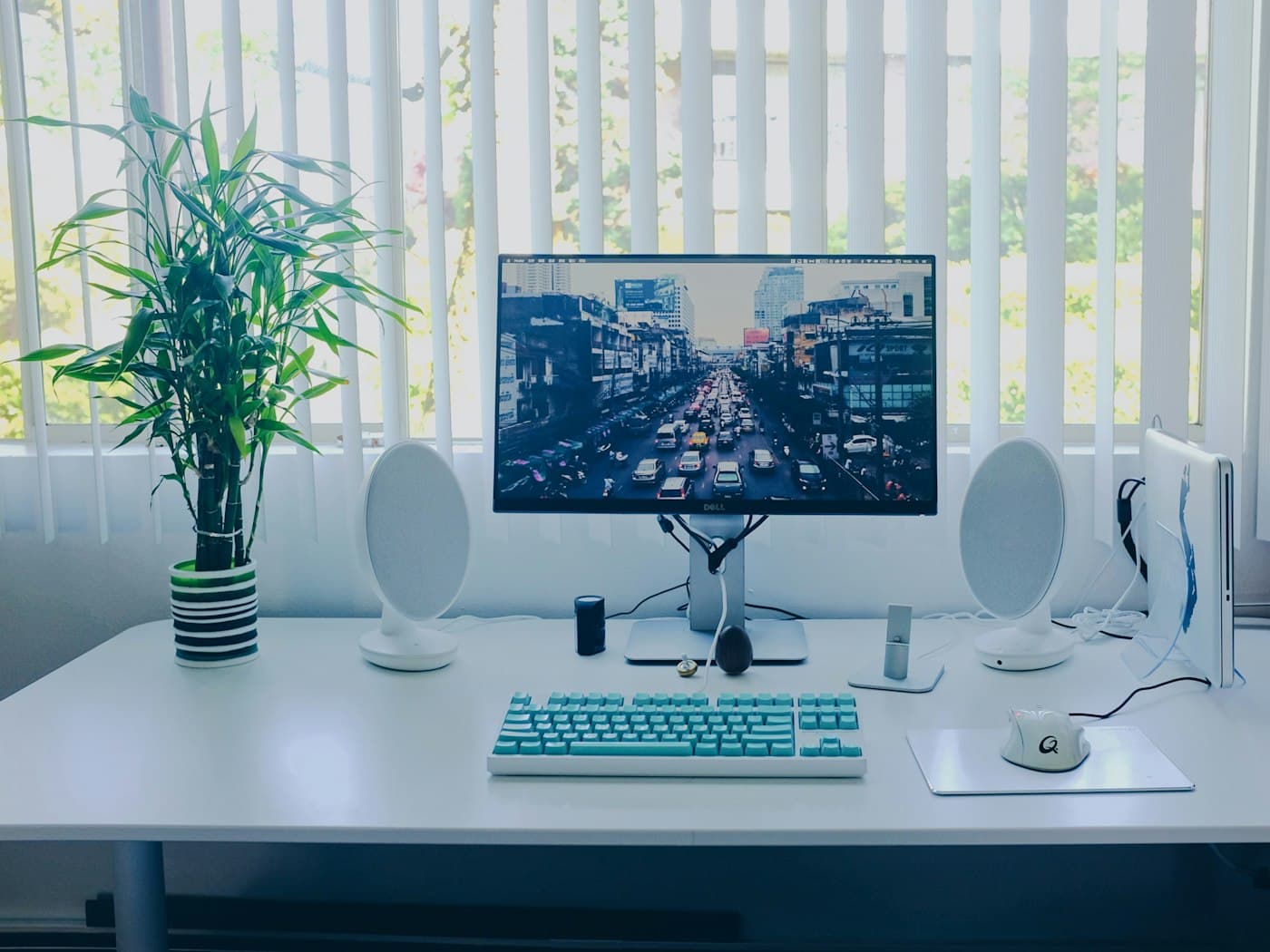 A desktop computer, keyboard and mouse set up on a work desk.